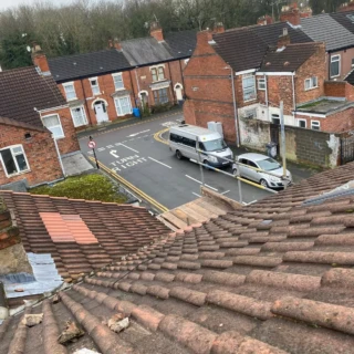 View from a terraced house roof looking down towards the street during a roofing inspection in Hull.