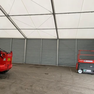 Interior of industrial shelter showing steel cladding walls and machinery on-site in Hull.