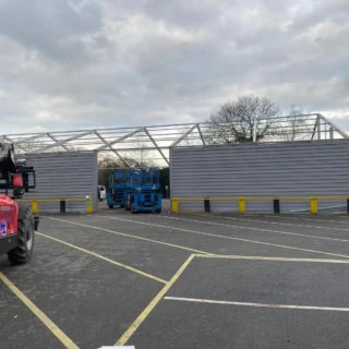 Manitou telehandler parked in front of a commercial temporary building under construction in Hull.