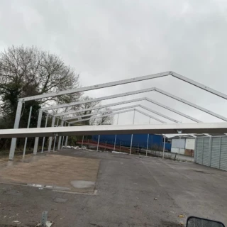 Steel portal frame roof structure assembly for a commercial building in Hull.