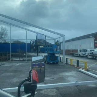 Operative using a scissor lift to secure structural steel frames on-site in Hull.